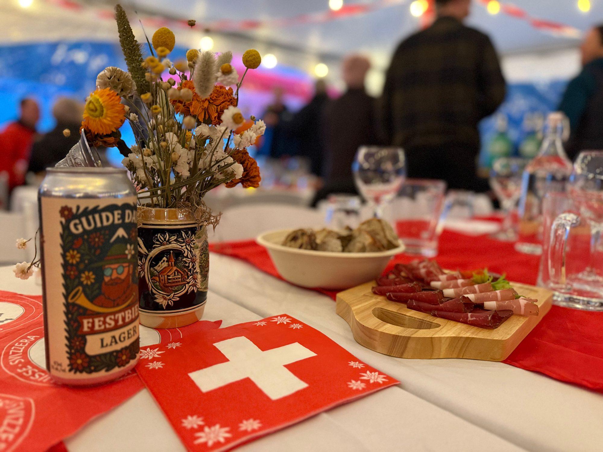Swiss flags, Festbier and a charcuterie board on a Guide Days table
